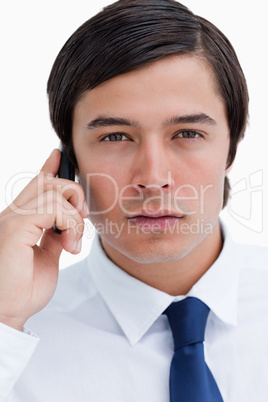 Close up of serious tradesman on his cellphone