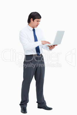 Side view of tradesman working on his laptop