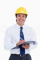 Smiling male architect with clipboard and pen