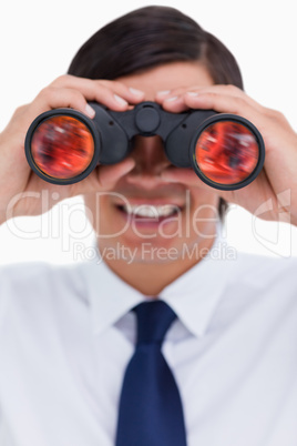 Close up of smiling tradesman looking through binoculars