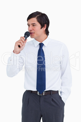 Close up of young tradesman talking with microphone