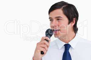 Close up side view of young tradesman with microphone