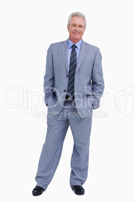 Smiling mature tradesman with his hands in his pockets