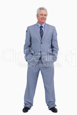 Smiling mature tradesman with hands in his pockets