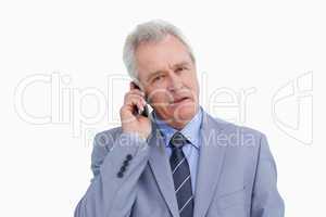 Close up of mature tradesman on his mobile phone