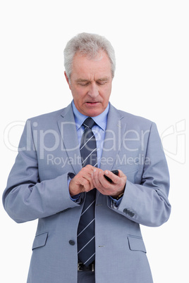 Mature tradesman writing a text message