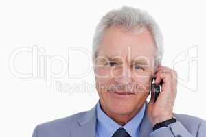 Close up of mature tradesman on his cellphone