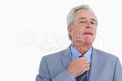 Close up of mature tradesman adjusting tie