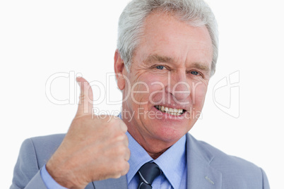 Close up of smiling mature tradesman giving thumb up