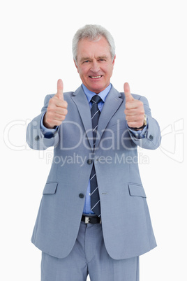 Smiling mature tradesman giving his thumbs up