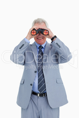 Smiling mature tradesman looking through spy glass