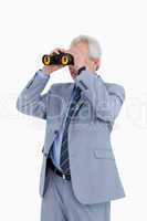 Mature tradesman looking through spy glass