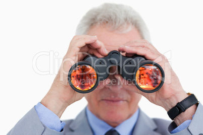 Close up of mature tradesman looking through spy glass
