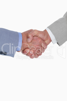 Close up side view of shaking hands