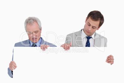 Tradesmen looking at blank sign in their hands