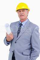 Confident mature architect with helmet and plans