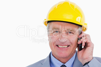 Smiling mature architect on the phone