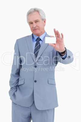 Mature tradesman presenting his business card