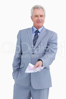 Mature tradesman with bank notes in his hand