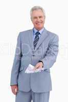 Smiling mature tradesman holding bank notes in his hand