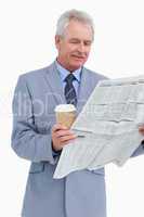 Mature tradesman with news paper and paper cup
