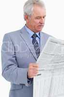 Mature tradesman reading the news paper