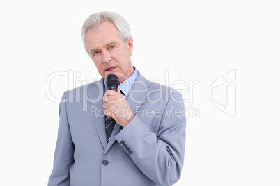 Mature tradesman speaking into microphone