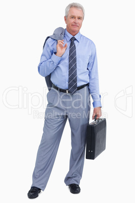 Mature tradesman with suitcase and jacket over his shoulder