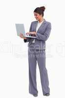 Smiling female entrepreneur working on her laptop