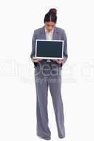 Female entrepreneur looking at her laptop in her hands