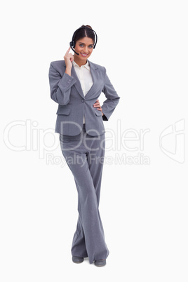 Smiling female call center agent with her legs crossed