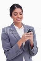 Smiling female entrepreneur writing text message
