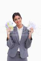 Smiling female entrepreneur holding bank notes