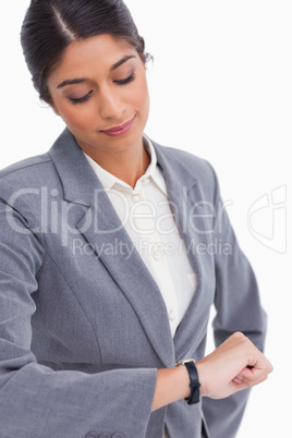 Close up of female entrepreneur looking at her watch