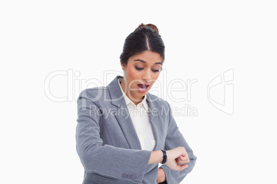 Shocked female entrepreneur looking at her watch