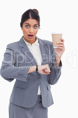 Shocked female entrepreneur with paper cup just checked the time