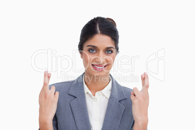 Smiling female entrepreneur with her fingers crossed