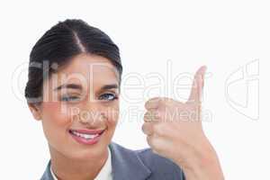 Close up of smiling female entrepreneur giving thumb up