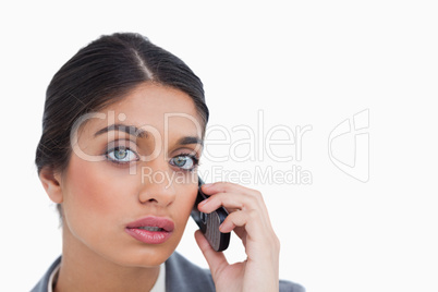 Close up of female entrepreneur listening to caller