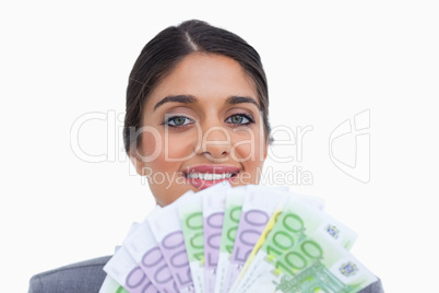 Close up of smiling female entrepreneur with bank notes