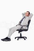 Side view of smiling businessman leaning back in his chair