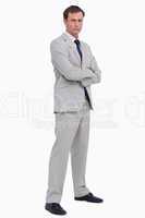 Serious businessman standing with his arms folded