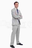 Smiling businessman standing with his arms folded