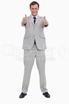 Smiling businessman giving thumbs up