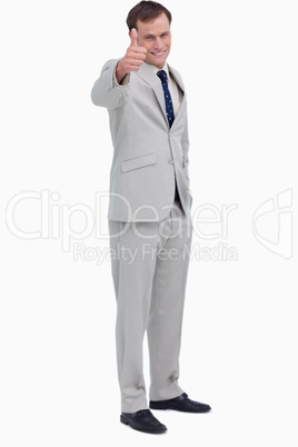 Smiling businessman giving thumb up