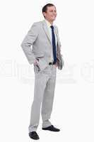 Smiling businessman with hands in his pockets