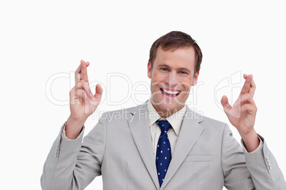 Close up of smiling businessman with his fingers crossed