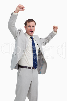 Celebrating businessman with his arms up