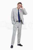 Smiling businessman on his mobile phone