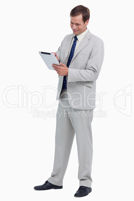 Smiling businessman using tablet computer